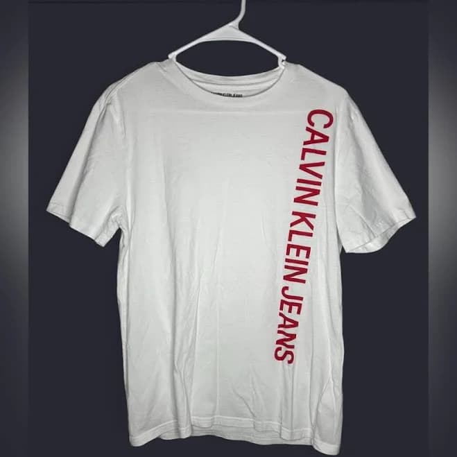 Calvin Klein Jeans Shirts | Calvin Klein Jeans White Tee With Vertical Red Logo | Color: Red/White | Size: M | Lucky11karma's Closet