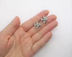 Rhinestone flower studs: Subtle and classic silver tone stud back flower shaped brilliant cut rhinestone earrings, rhinestone flower studs
