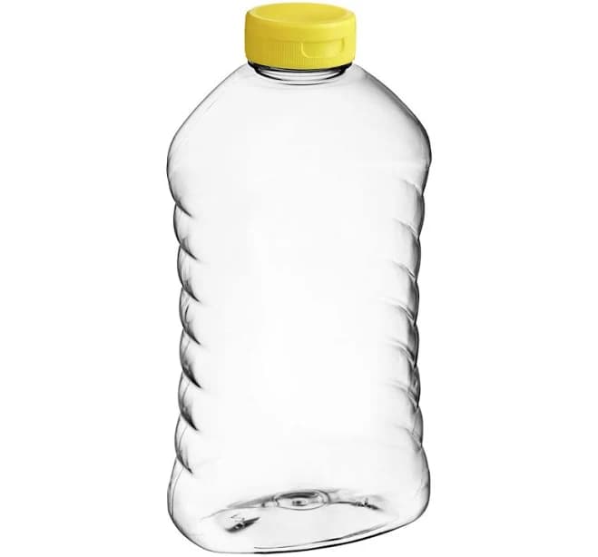 27 oz. (40 oz. Honey Weight) Ribbed Hourglass PET Honey Bottle with Pressure Sensitive Liner Yellow Plastic Flip Top Lid - 135/Case