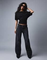 Low-rise baggy jeans with studs, pockets and stars - Trousers - Women | Bershka