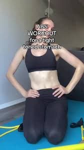 Workout Guide With Resistance Pilates Bar Stomach Exercises A Woman Is Sitting On The Floor With Her Arms In The Air While Holding Two Pink Cords